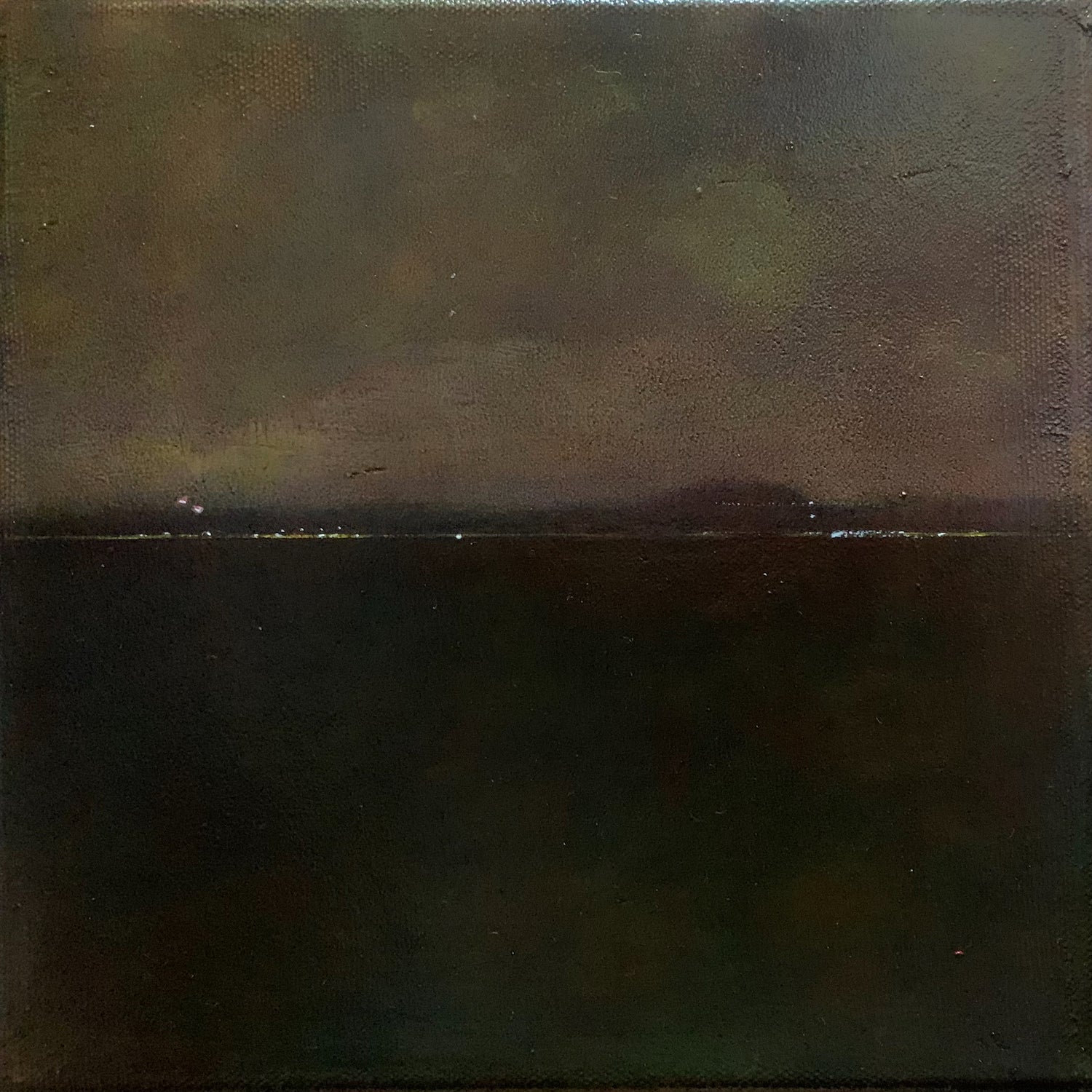 Collection of Andrew Torr - Nocturne - Victoria Park: A moody oil painting depicting a dark nighttime landscape with distant twinkling lights along the horizon, creating a serene contrast between the shadowy foreground and illuminated background on a 20x20cm canvas. in a gallery layout